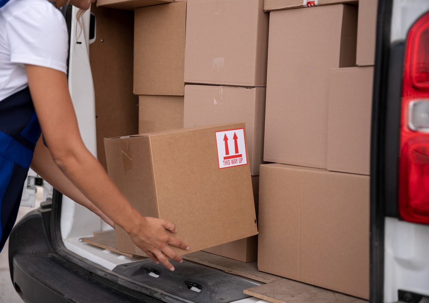 Courier loading package into delivery van for same day courier service